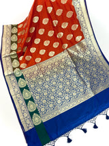 Statement Handmade Burnt Orange Color Banarasi Soft Katan Silk Saree with Floral Buttas with Mehandi Green and Blue Border and Pallu