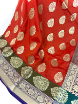 Statement Handmade Burnt Orange Color Banarasi Soft Katan Silk Saree with Floral Buttas with Mehandi Green and Blue Border and Pallu