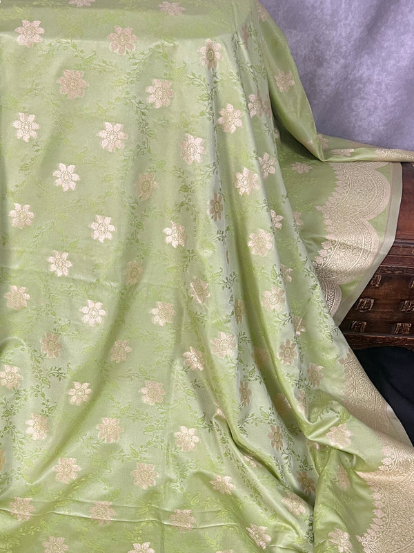 Pastel Pista Green Banarasi Butter Silk in Muted Gold Zari with Floral Design with Tanchoi Weave and Scalloped border | Soft Silk Sarees