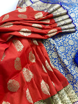 Statement Handmade Burnt Orange Color Banarasi Soft Katan Silk Saree with Floral Buttas with Mehandi Green and Blue Border and Pallu - Kaash