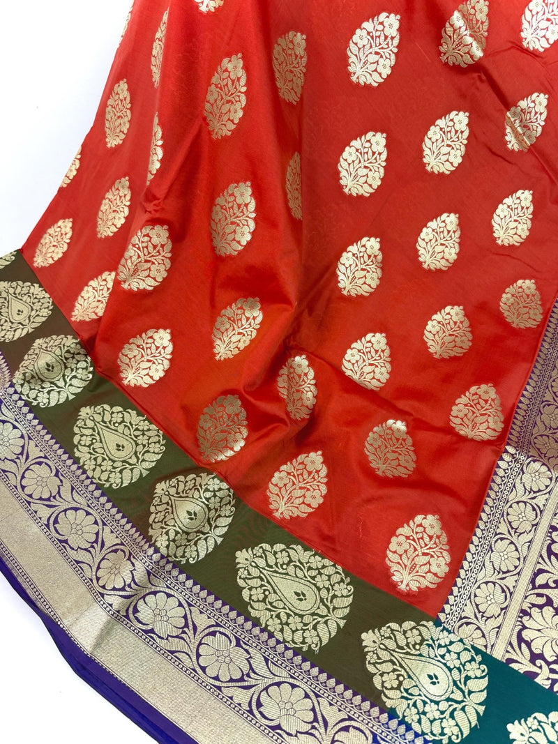 Statement Handmade Burnt Orange Color Banarasi Soft Katan Silk Saree with Floral Buttas with Mehandi Green and Blue Border and Pallu - Kaash